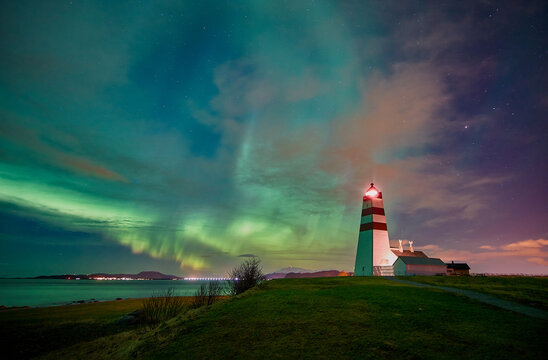 Northern lights dancing over Alnes lighthouse on Godøy, Norway