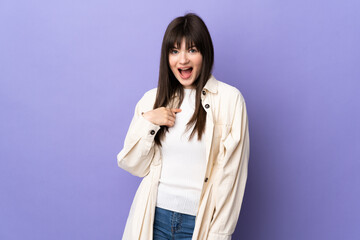 Young Ukrainian woman isolated on purple background with surprise facial expression