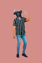 man with a cow mask speaks into a microphone