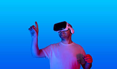 young man using virtual reality glasses using virtual touch screen.