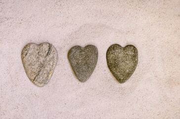 Row Of Stone Hearts On Sand