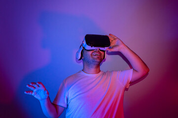 young man using virtual reality glasses is getting happy.