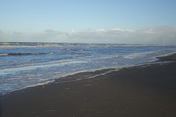 Rolling North Sea waves at the beach on a sunny stormy winter morning, Egmond aan Zee, North Holland, Netherlands 