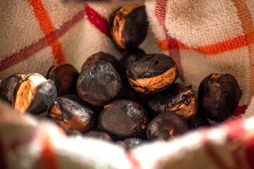 Close up view of roasted chestnuts on a kitchen towel.