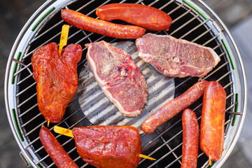 picture of a barbecue with meat and sausages