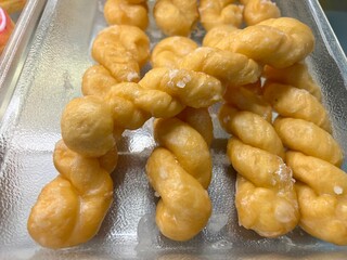 Close-up photo of Sugar twist, a dessert made from flour and sugar. It is commonly consumed by the general public. It smells delicious and colorful.