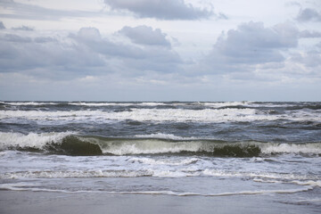 Stormy weather at the sea with clouds and waves