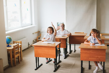 Class at school, children sitting studying at desks, school learning concept