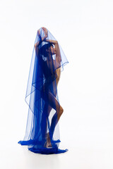 Artistic girl, young Japanese ballerina dancing with transarent blue fabric in art performance...