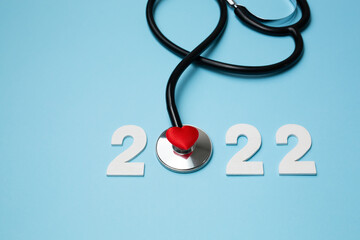 2022 wooden number with stethoscope. Happy New Year for heart health and medical concept, life...