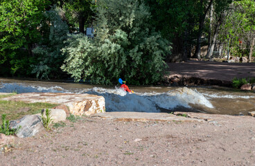 Naklejka premium Facing the rapids in a kayak keeping safety in mind