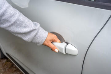 woman's hand opens white car door. Woman opens car door. Business woman opening car door, holding handle. Close up of hand female driver open car door. close up