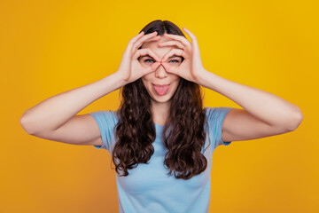 Fototapeta na wymiar Close up photo of young cheerful girl happy positive smile show okay sign fooling tongue-out isolated yellow background