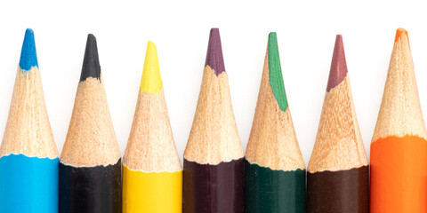Multi-colored pencils on a white background.