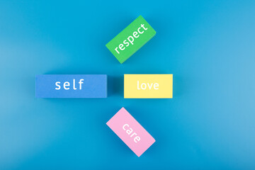 Mental health formula concept. Self respect, love and care written on multicolored rectangles on...