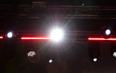 Spotlights at a concert at night.