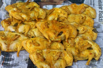 A stall selling fried chicken in a traditional market