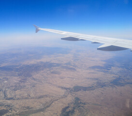 Airplane wing in sky in flight.