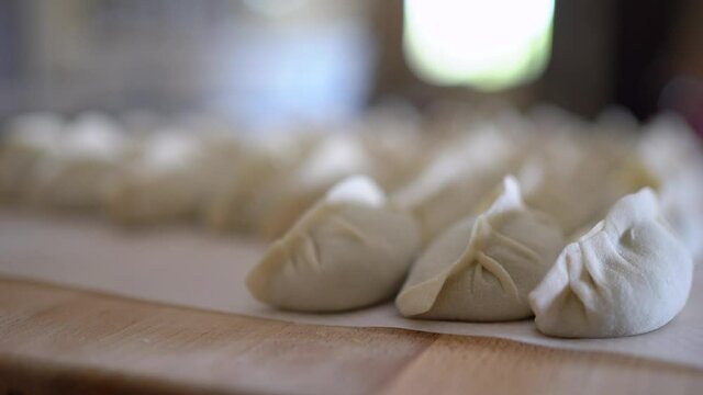Raw jiaozi dumplings served on table