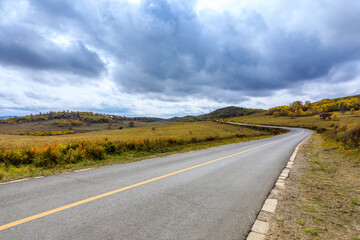 Empty asphalt road pavement and sky clouds on a cloudy day.