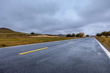 Empty asphalt road pavement and sky clouds on a cloudy day.Road ground scene after rain.