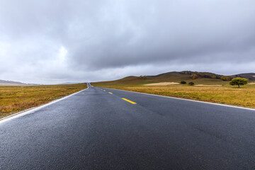 Empty asphalt road pavement and sky clouds on a cloudy day.Road ground scene after rain.