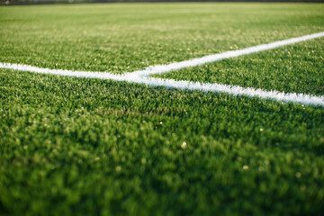 green synthetic grass surface on a soccer ground, european football field with artificial grass - obrazy, fototapety, plakaty