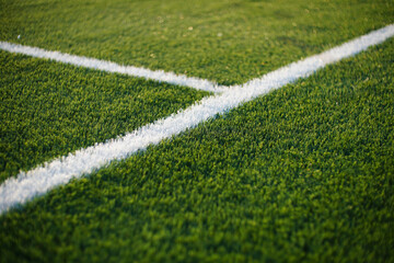 green synthetic grass surface on a soccer ground, european football field with artificial grass