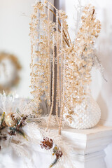 Christmas interior decoration. Glass beads decoration on white fireplace.