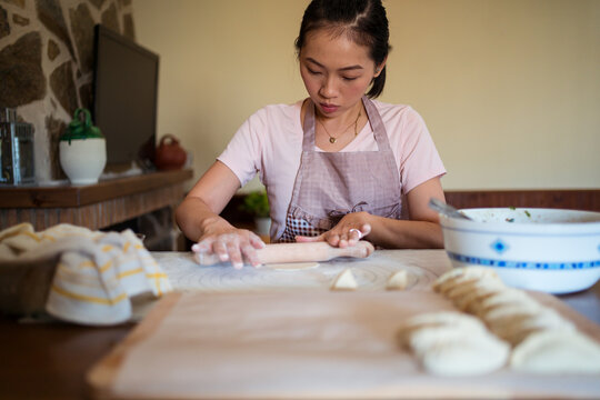 Housewife kneading dough in kitchen