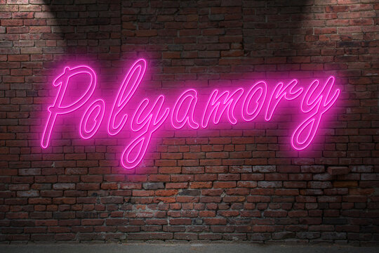 Neon Polyamory (in german Polyamorie) lettering on Brick Wall at night