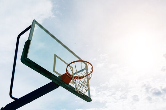 Basketball hoop on playground against blue sky