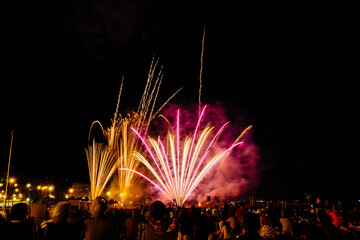 Sky with colorful firework blast launched by the beach