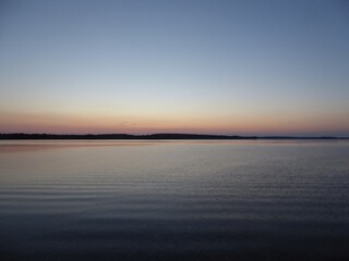 Obraz premium The calm surface of the Mueritz in the Mueritz National Park Mecklenburg-Western Pomerania, Germany in the evening