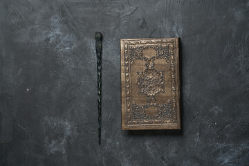 Subjects of the school of magic. Book of spells on dark grey background.