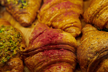 Appetizing croissant with strawberry or raspberry in a pastry shop window. Closeup.