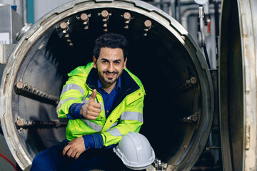 Fototapeta na wymiar portrait engineer worker happy smiling working in factory sitting relax thumbs up