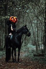 a beautiful girl in a Halloween costume. a gloomy image for cosplay. a rider in a black cloak riding a black horse. pumpkin mask with glowing eyes