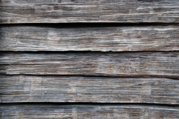 Fototapeta premium a fence made of old unpainted wooden boards for a natural gray background