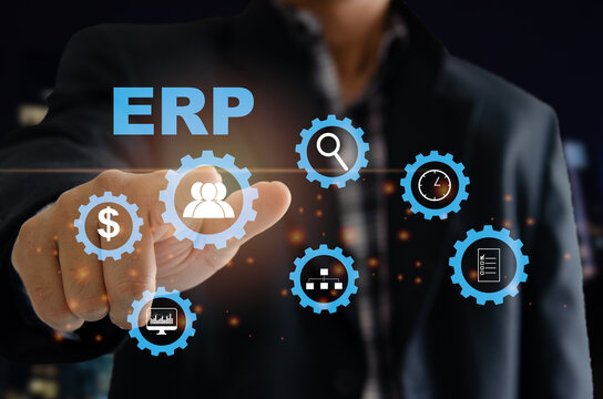 Enterprise Resource Planning (ERP) Software system for business resource plans. A man's hand touches the ERP word on a virtual screen.