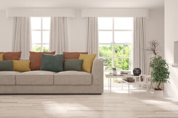 Stylish room in white color with sofa and summer landscape in window. Scandinavian interior design. 3D illustration