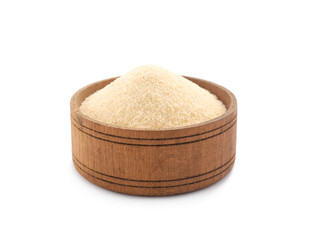 Uncooked organic semolina in bowl isolated on white