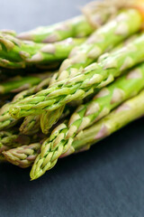 Fresh of green Asparagus. Cooking healthy meal. Bunches of green asparagus. Selective focus. Vertical photo