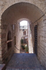 Fototapeta premium Typical alley with staircase in the medieval old town of Assisi, Italy