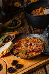 Polish bigos cooked according to an old recipe with wine and plum