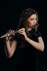 Close-up of the hands of a woman playing the flute. Musical concept.