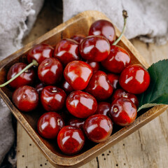 Ripe red cherries on a wooden table