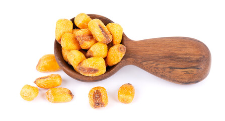 Roasted salted corn nuts in wooden spoon, isolated on white background. Beer snack, dry corn with spices.