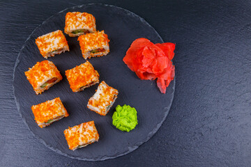 Sushi rolls Philadelphia on a black slate. Top view