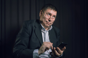 a man in a business style with a phone
